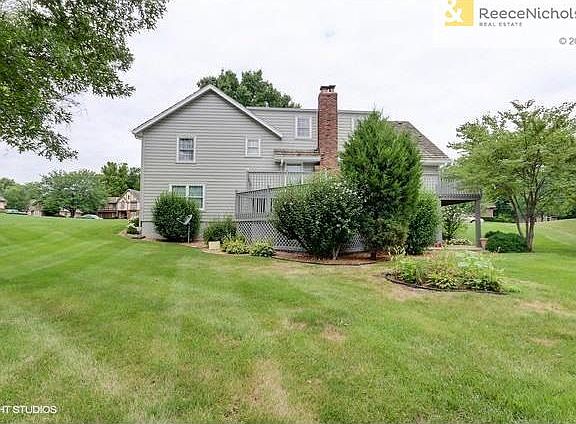Back of house with 2 tiered deck
