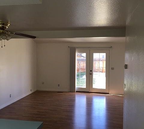 Great room and French doors leading out to back patio and fenced yard.