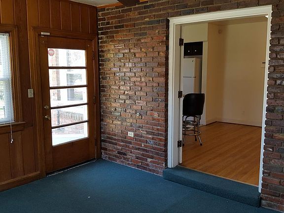 Sun Room off of dinning room has plenty of light and exposed brick walls