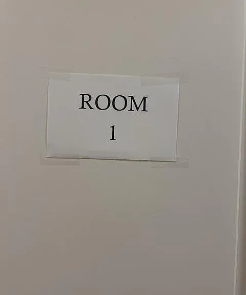 Interior door labeled "Room 1," indicating a private room entrance within the home.