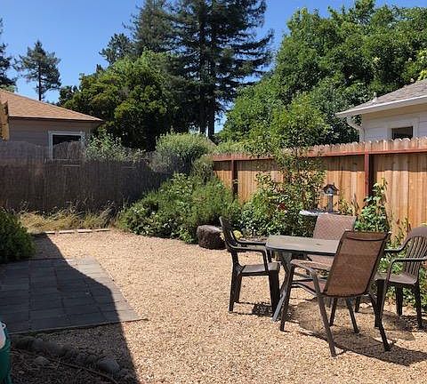 View of the back yard from vantage point of front fence gate.