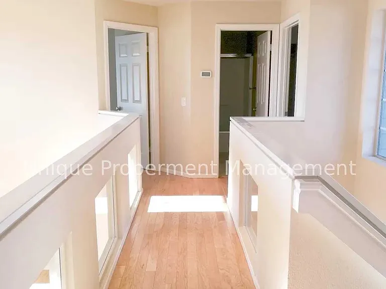 hallway to the other 2 bedrooms and bathroom