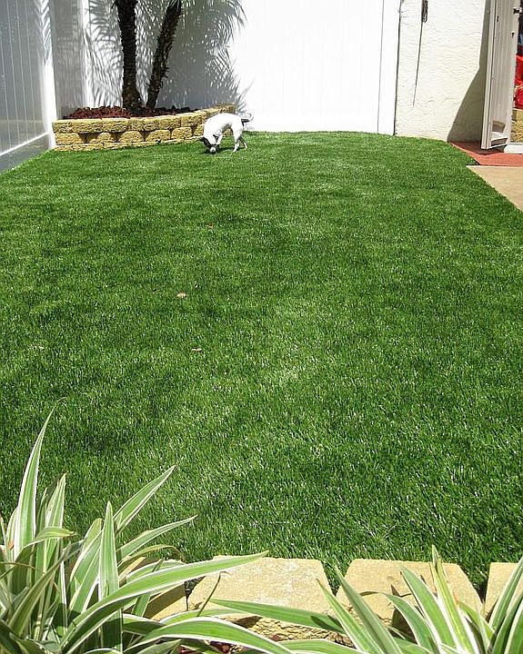 Vinyl fenced back yard/patio with turf installed