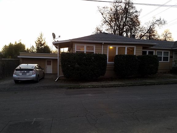 Street view of this end unit of the triplex, with garage.
