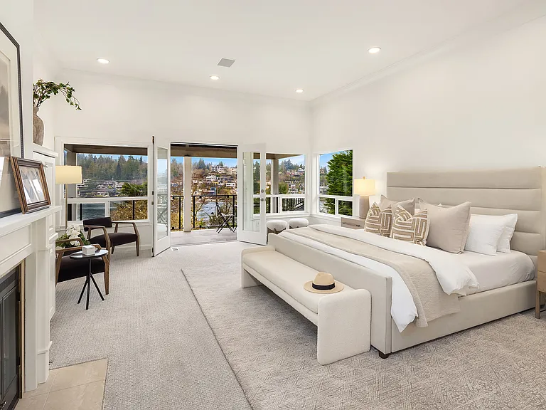 A large primary suite, with a private deck overlooking puget sound