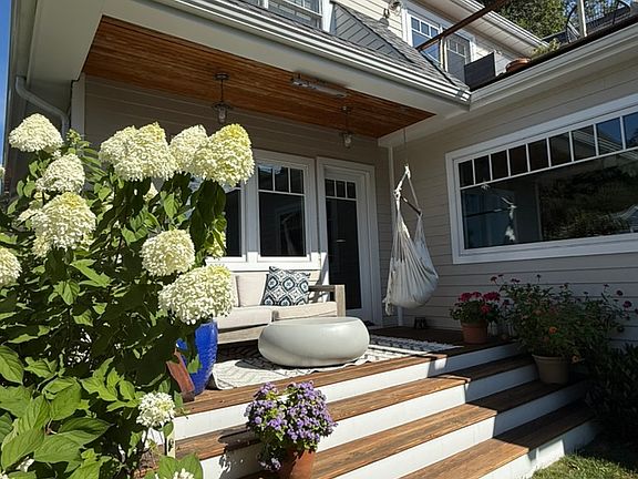 Front porch with couch, hammock chair and overhead heater