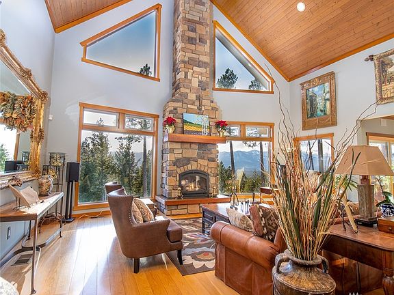 Soaring vaulted ceilings in this great room/living space. Remodeled in 2018 with even larger windows to bring the outside in.