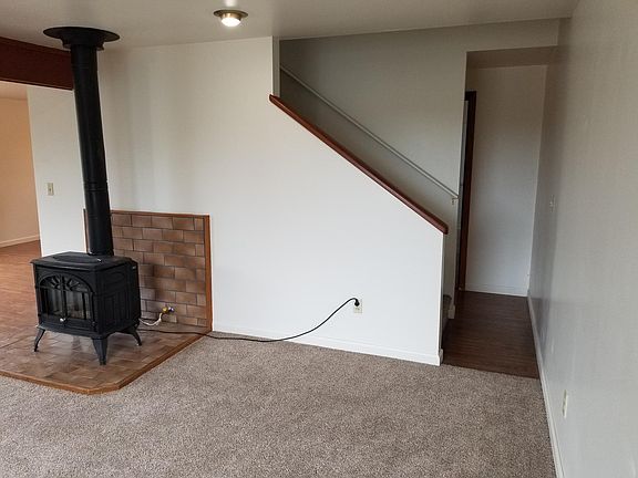 living room with access to upstairs bedrooms and hallway to bathroom