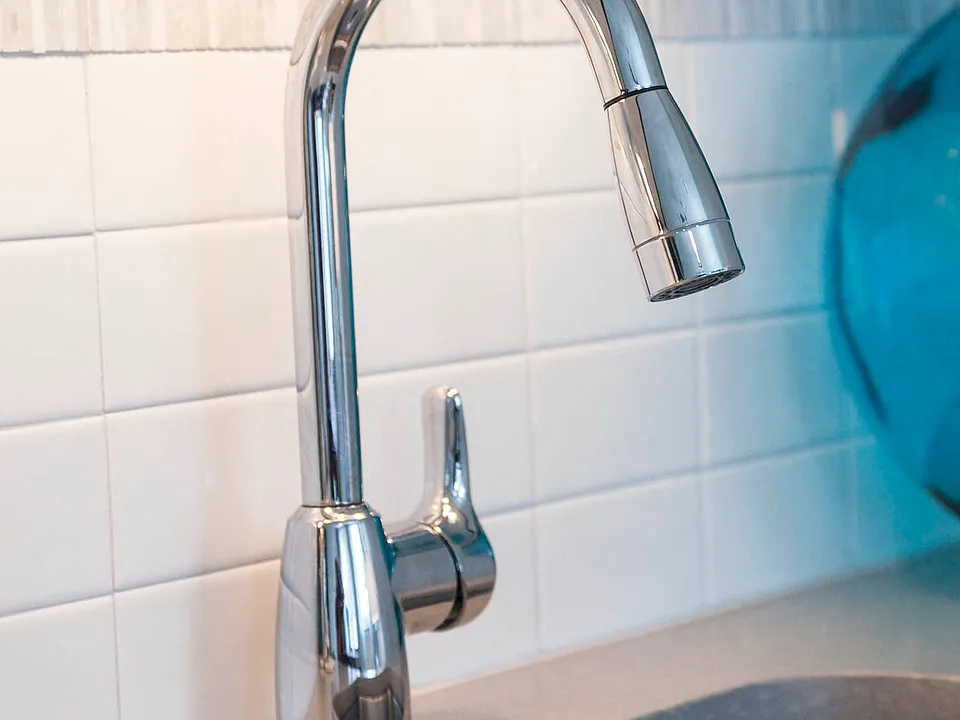 Quartz countertops with unique tiled backsplash