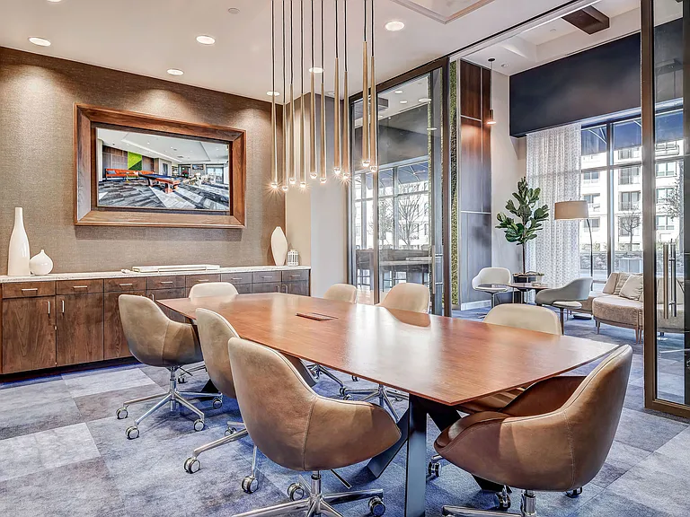 Modern conference room with stunning light fixtures and a TV
