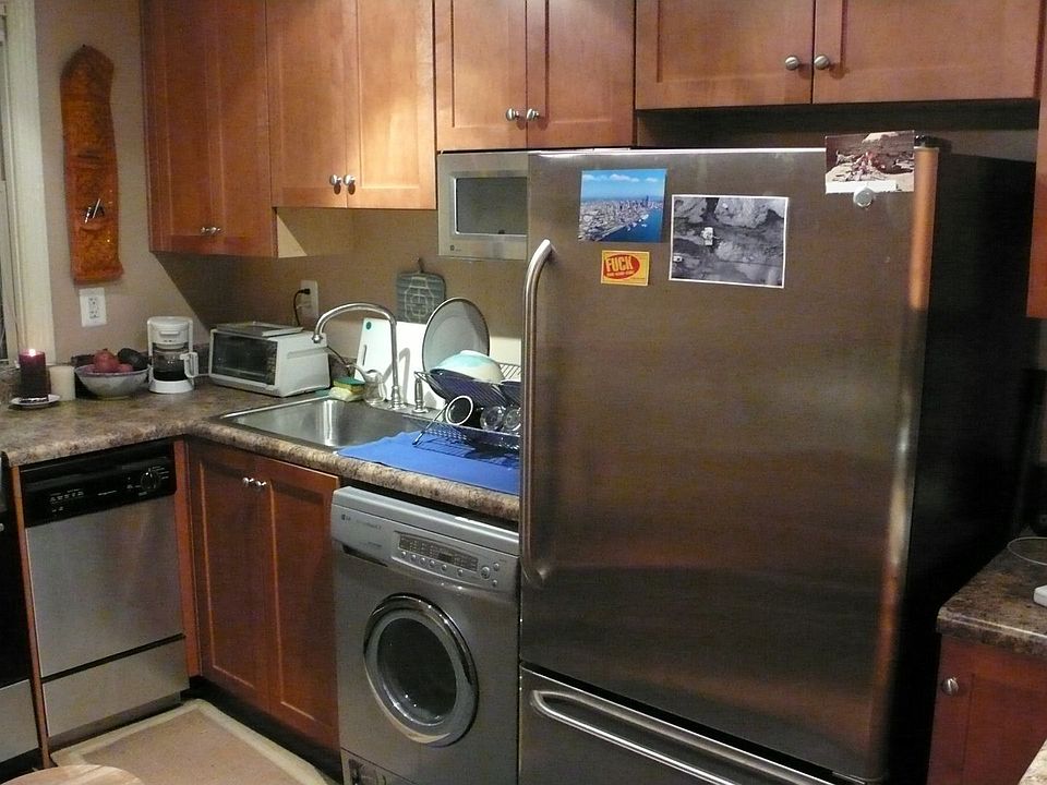 Kitchen with combo washer-dryer and dishwasher. Gas stove.