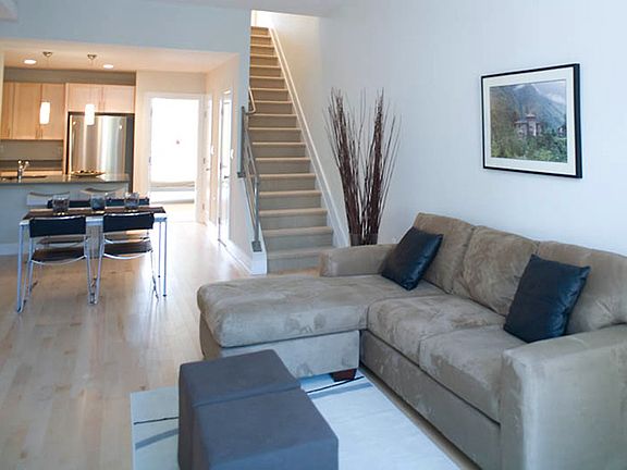 Bright and spacious living area with hardwood floors, open layout, and modern furnishings _ perfect for relaxing or entertaining.