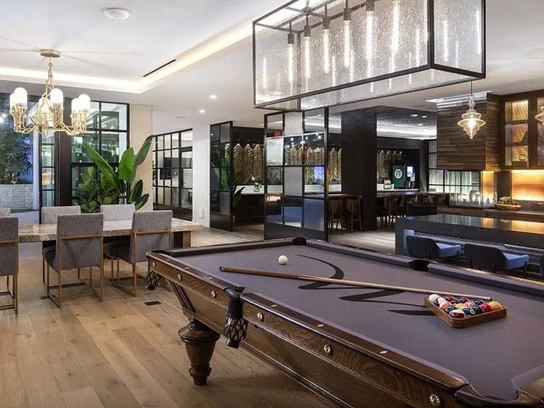 Gaming area with billiards leading to outdoor lounge areas