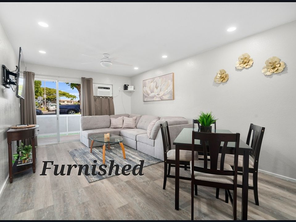 FULLY FURNISHED UNIT! Living room with tasteful furnishing and decor. Sliding door to lanai.