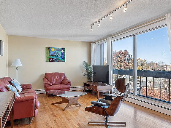 Living Room with oversized sliding door, balcony and AC