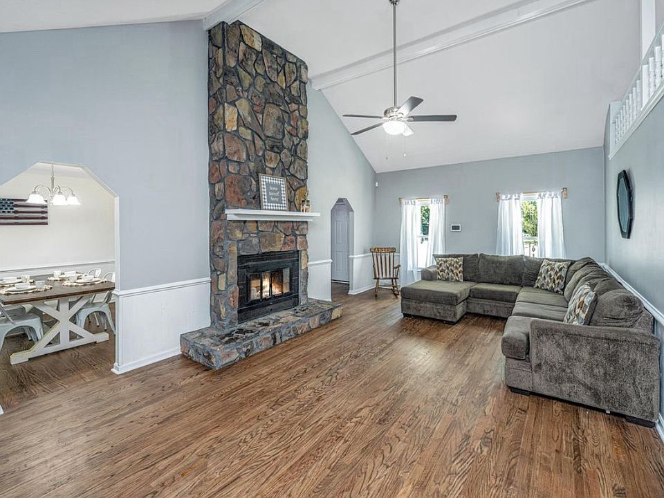 Large living room with vaulted ceilings and stone fireplace (wood, not gas)