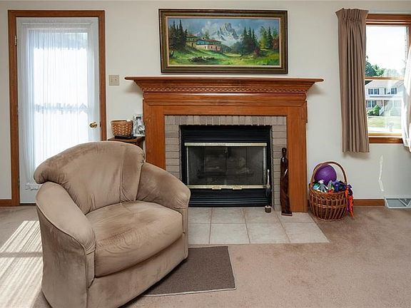 The gas burning fireplace is the focal point of the living room and is highlighted by the solid wood mantle.