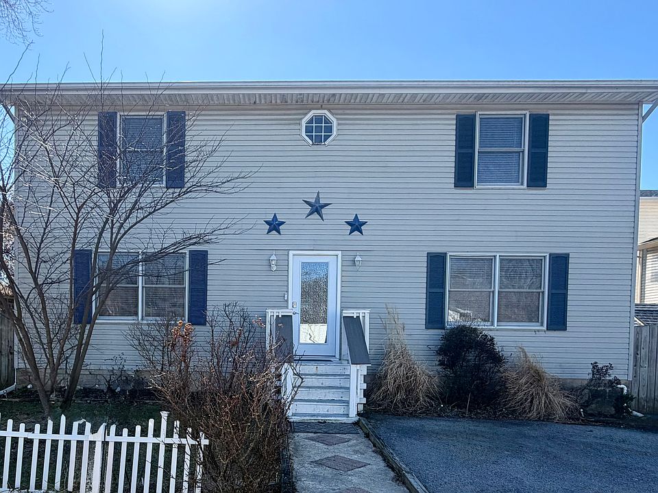 Street View of home and driveway that fits 3 vehicles.
