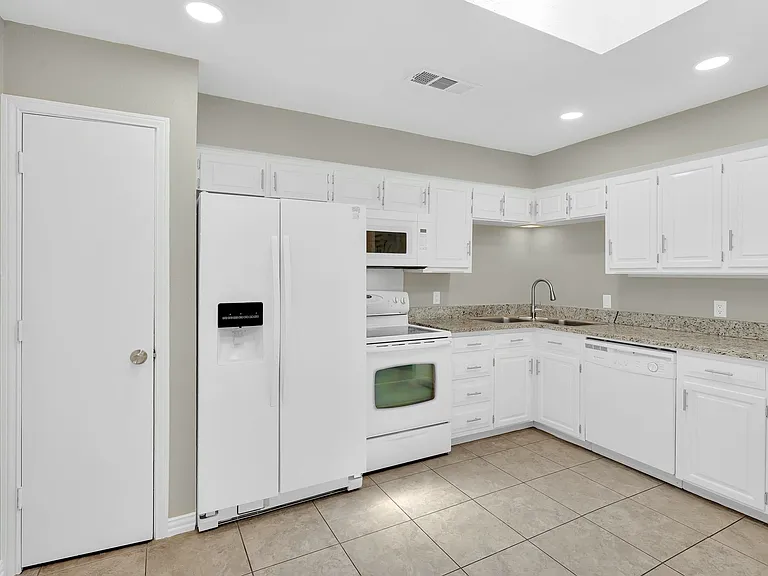 Pantry is conveniently located close to the fridge. Plenty of room for a floating island in this large kitchen.