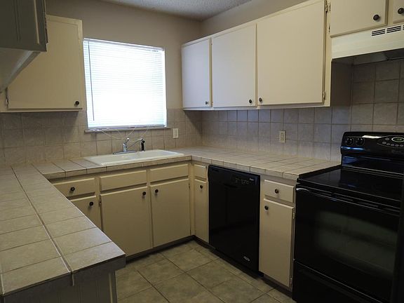 Kitchen includes stove, dishwasher and refrigerator