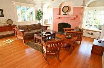 Grand formal living room anchored by a prominent fireplace 