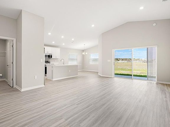 This home features a sunny, open living area with volume ceilings - Sophia by Highland Homes