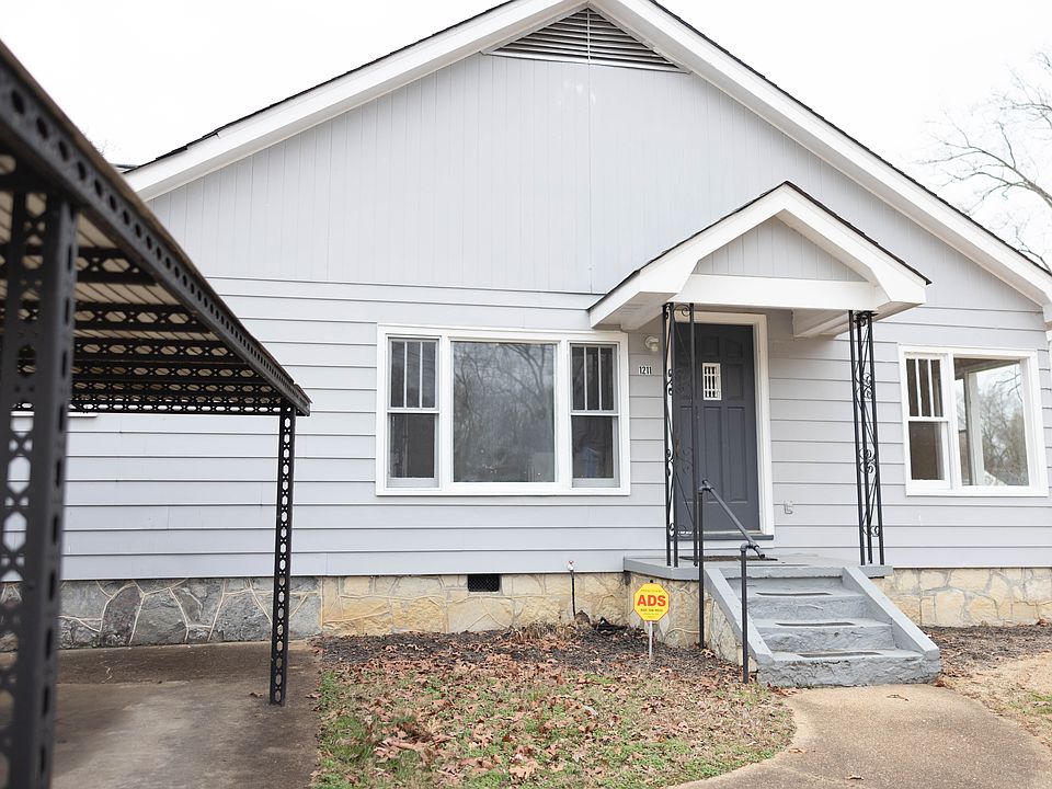 Exterior with covered entrance, separate driveway with covered parking