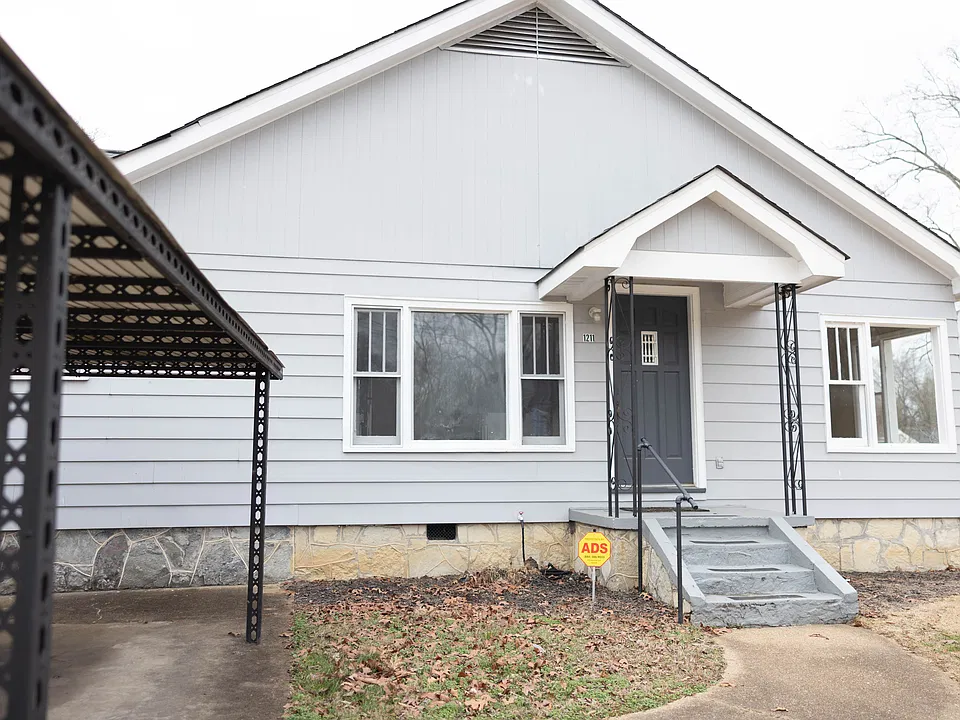 Exterior with covered entrance, separate driveway with covered parking