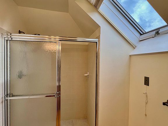 Bathroom for second bedroom, shower, skylight faces east.