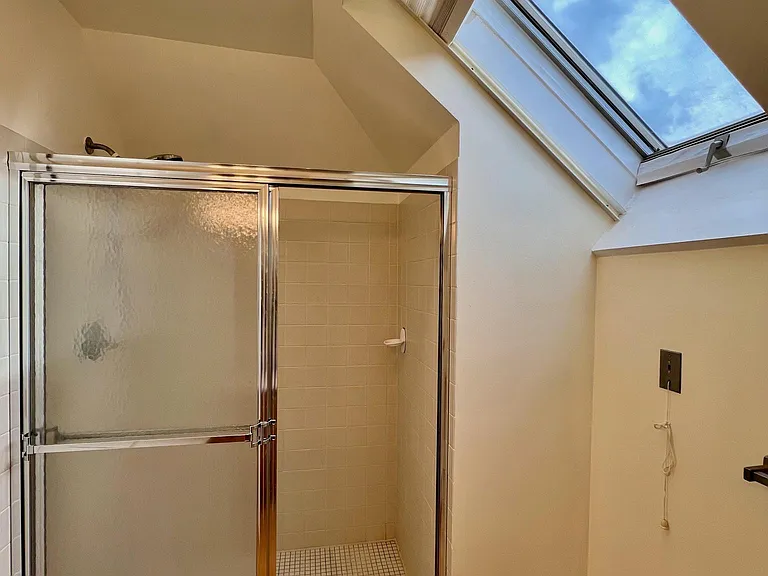 Bathroom for 2nd bedroom, shower, skylight faces east.