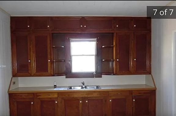 In front of this side, there is a stove and refrigerator.