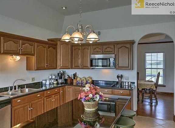 Large kitchen with island flows into formal dining room.