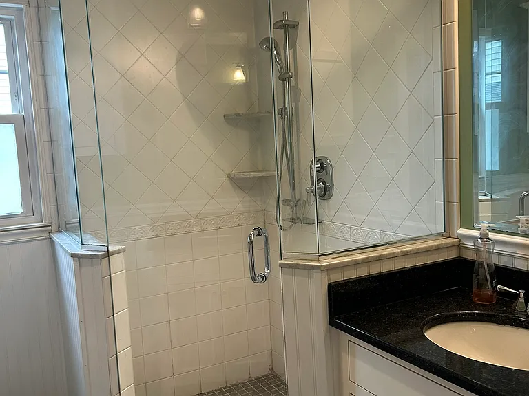 Bathroom: shower and first sink.
