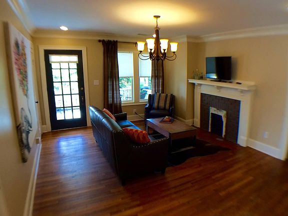A private staircase leads to a welcoming living room open to a sunny porch/balcony, spacious storage closet, and eat-in kitchen.