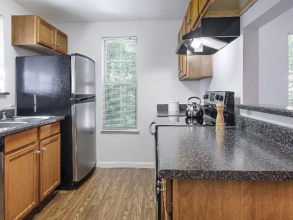 Fully Equipped Kitchen Featuring Hard-Surface Countertops and a Gleaming Suite of Appliances