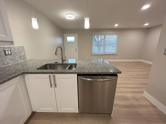 Peninsula dishwasher for easy loading/unloading. Outlets located near bar for charging or food warming.