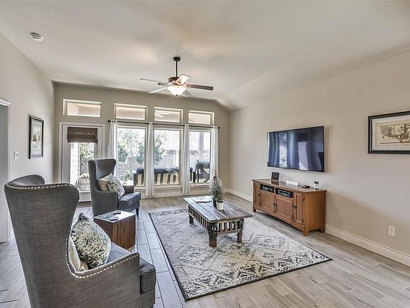 Beautiful open living space with a wall of windows looking into the backyard