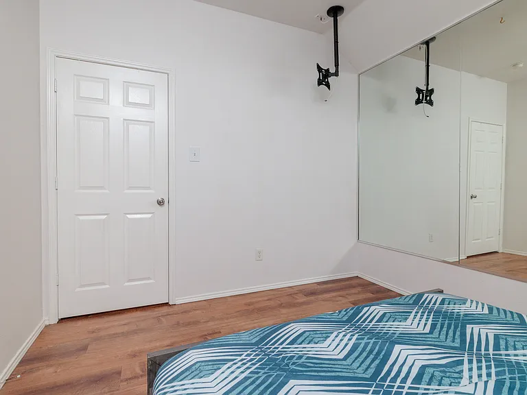 Bedroom #2 with queen size bed and mirrored wall.