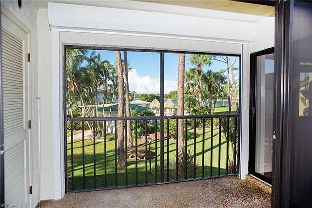 Gorgeous view from rear of condo looking over community pool and lake!