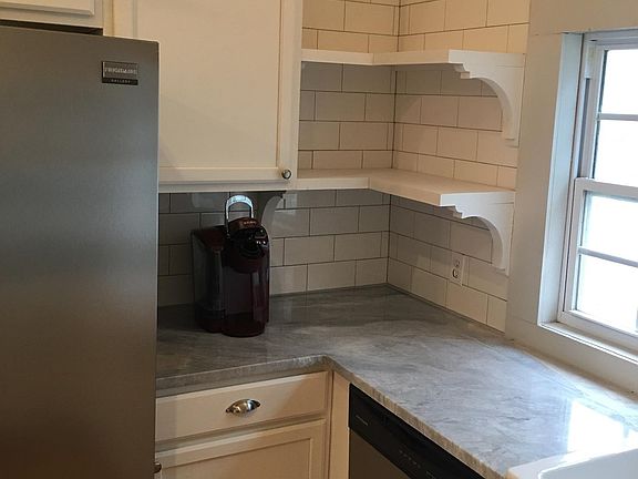 Dishwasher, cabinets, marble countertops