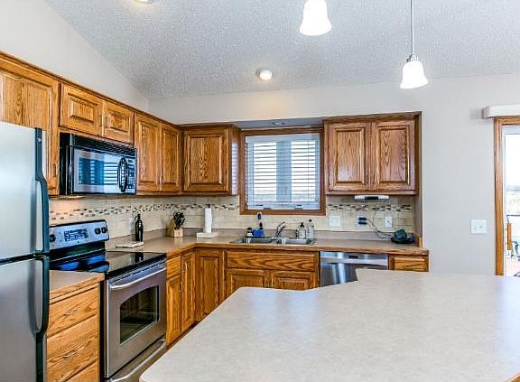 Stainless kitchen appliances and intricate ceramic back splash in this beautiful kitchen!