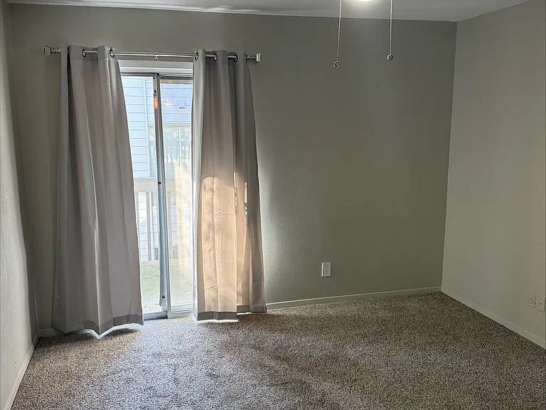 Bedroom with Ceiling fan and access to Patio.