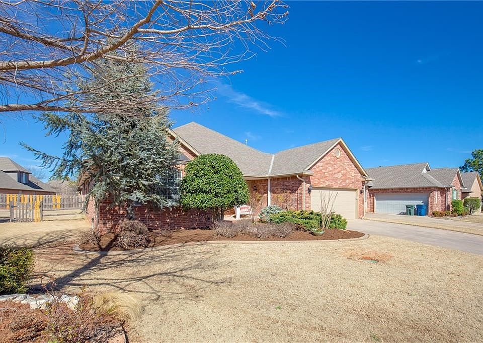 Patina'd bay window peeps through the landscape out front as this darling home is surrounded by mature groomed plantings that invite birds for viewing.