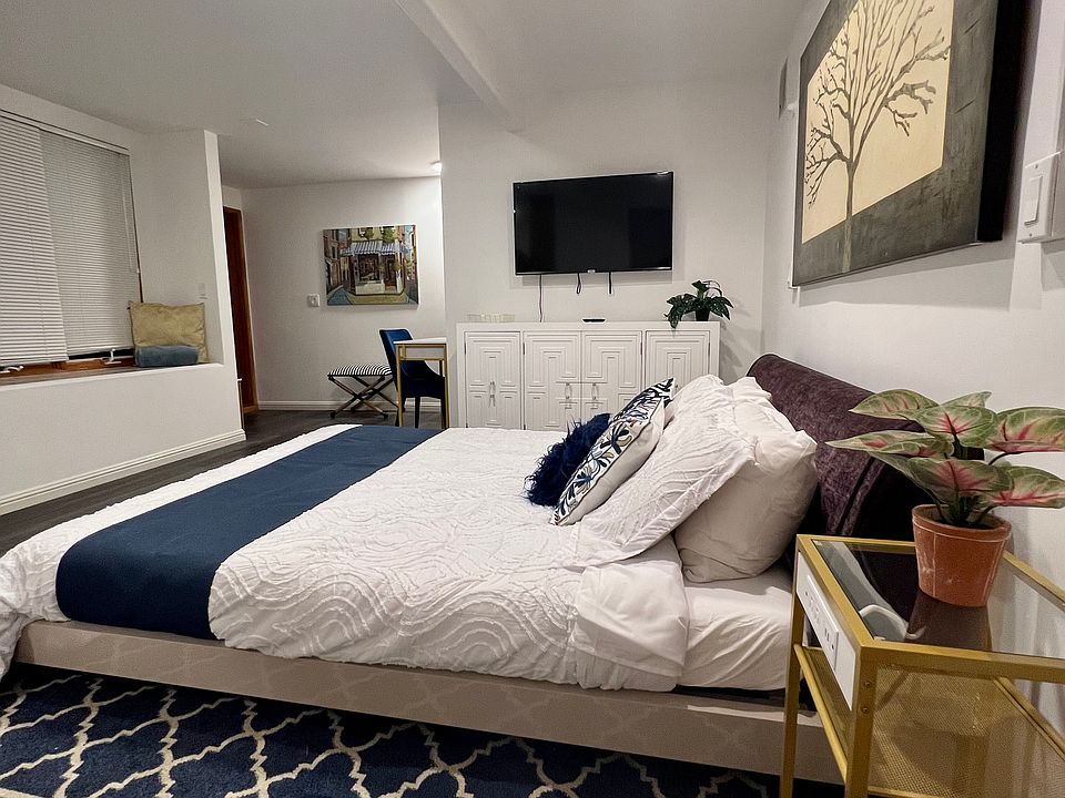 Queen size bed, dresser, and working desk.