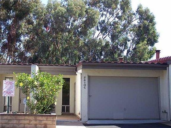 Front of unit showing one-car garage. Entrance to the street level first floor.