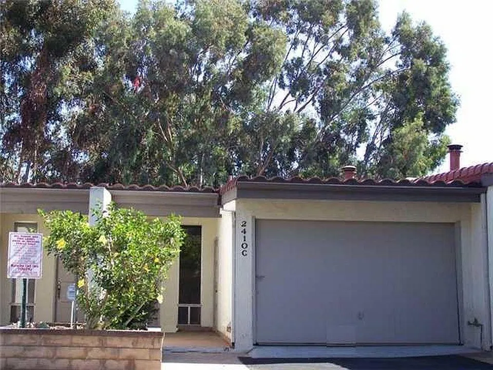 Front of unit showing one-car garage. Entrance to the street level first floor.