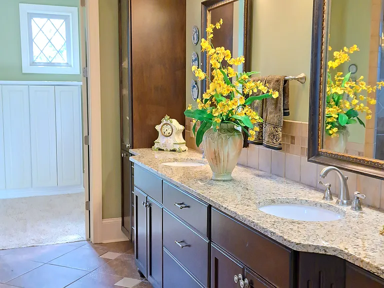 Master bath with built in shelving in spacious master closet