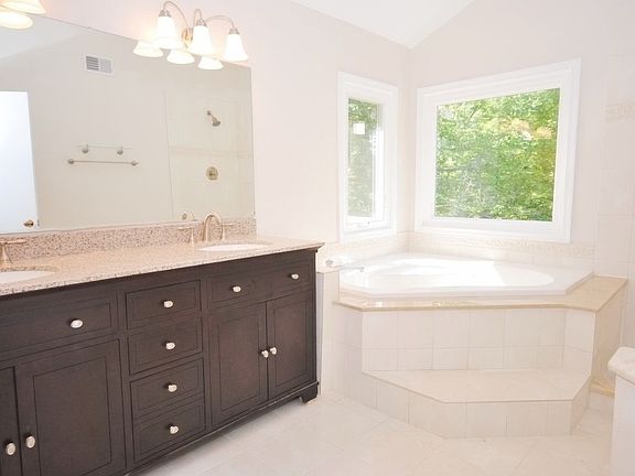 Double Granite Vanity with Soaking Tub in Master Bath