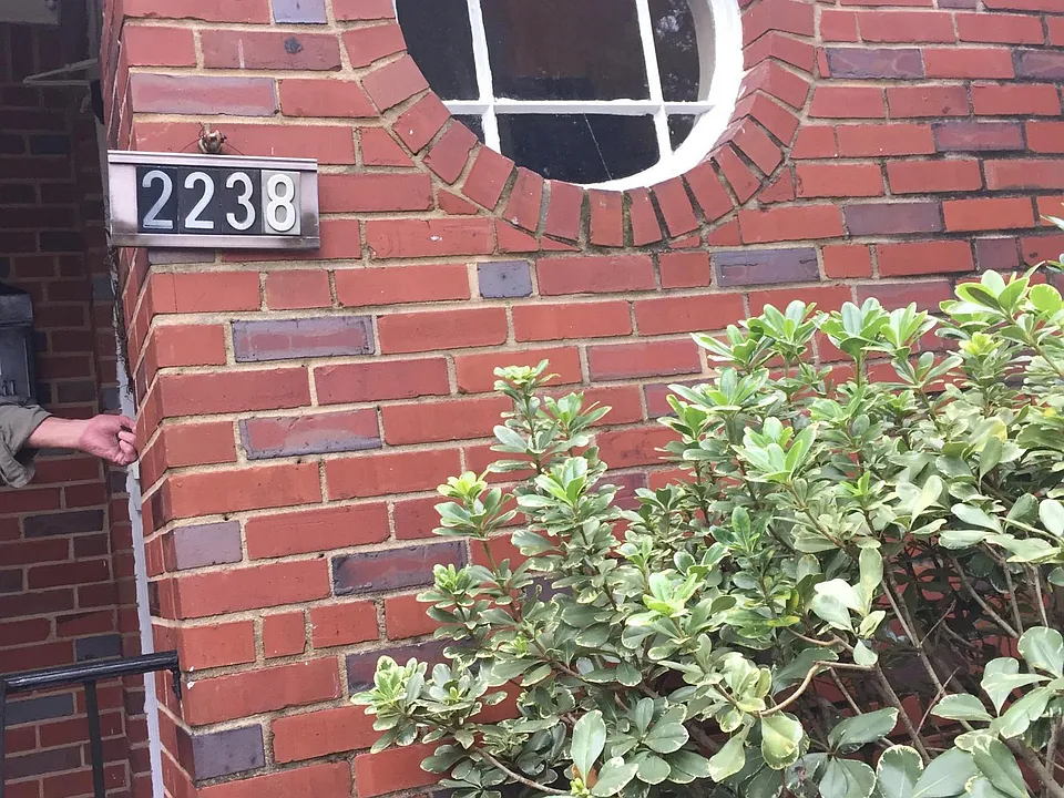 Address of building near porch and entry door