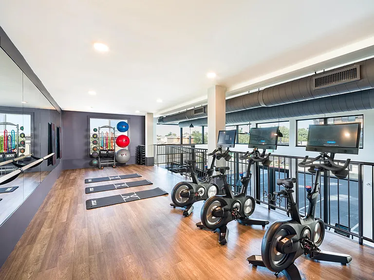 A refined fitness studio at Modera Higley Commons, featuring advanced training equipment and an open layout designed for focused, everyday movement.